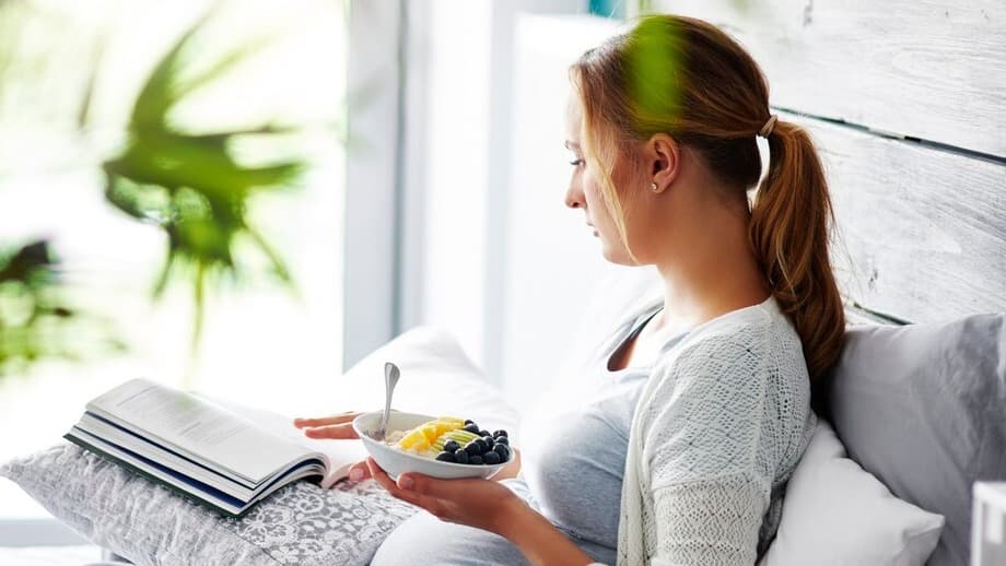 pregnant-woman-reading-book-bedroom_329181-18048.jpg
