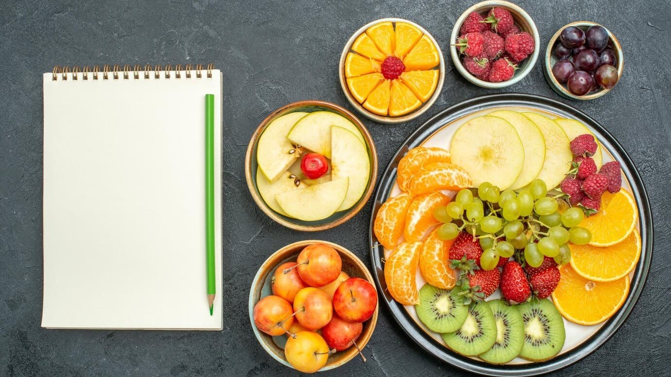 top-view-delicious-fruit-composition-fresh-sliced-fruits-dark-background-ripe-fresh-health-fruit-mellow_140725-116227.jpg