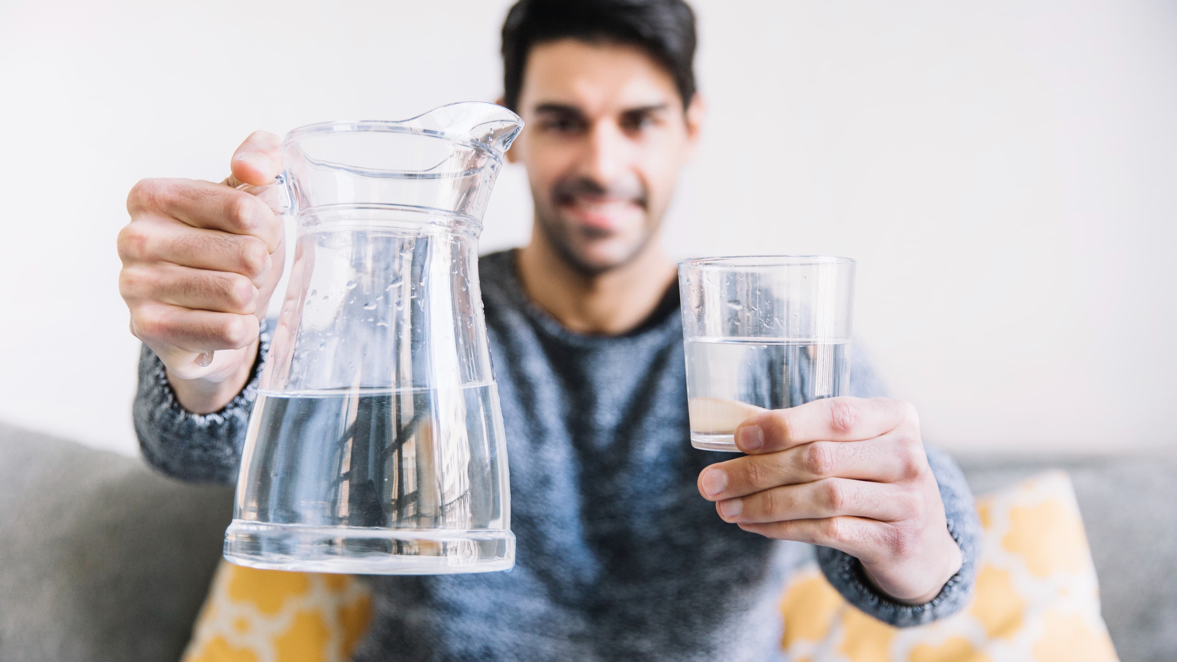 1915167-blurred-man-showing-jug-glass.jpg